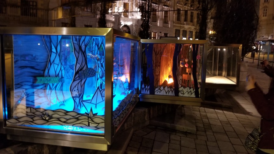 These art pieces appear on the outer edge of the entrance to an underground parking ramp.