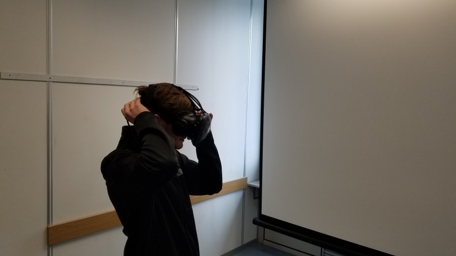 Iowa State student Jason Becker equips an HTC Vive VR headset at the TU Wien HCI Lab.