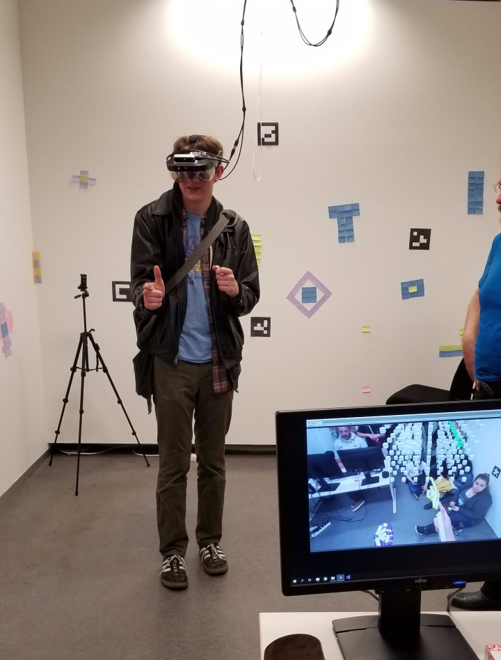 I try out a few hand gestures to select data in augmented reality. You can see my view in the bottom left.