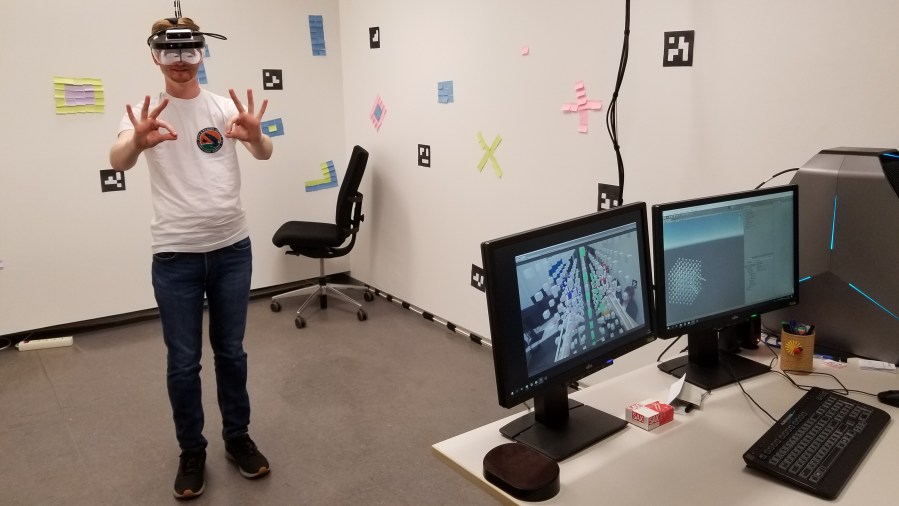 Jason Becker tries out some hand motions to manipulate data in augmented reality.